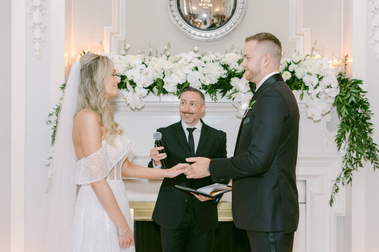 A wide view of an indoor ceremony in a fireplace room