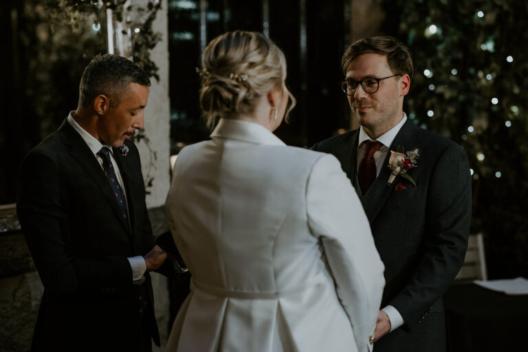 A couple walking back up the aisle after their ceremony