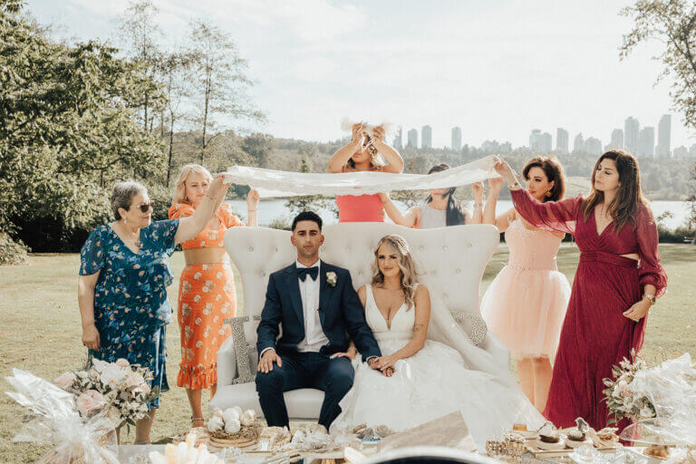 A joyful wedding party celebrating outdoors after the ceremony