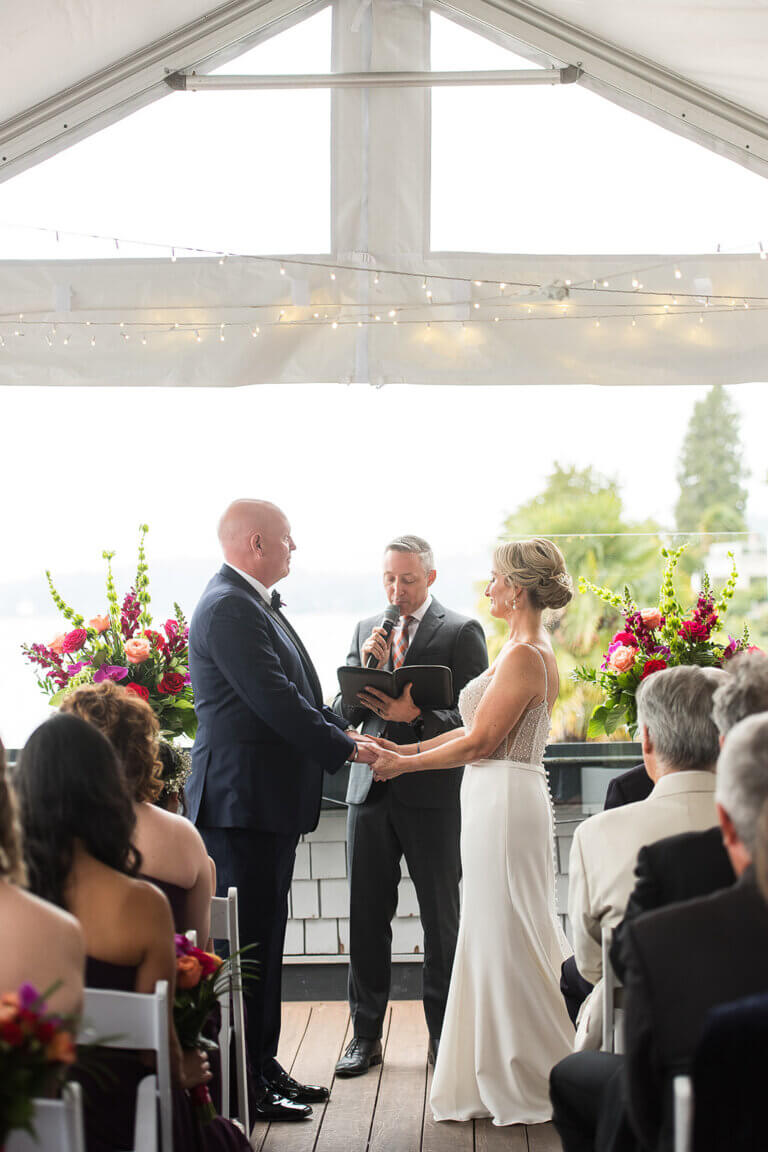Jonathan Evans officiating as Angela and Ryan hold hands during their ceremony
